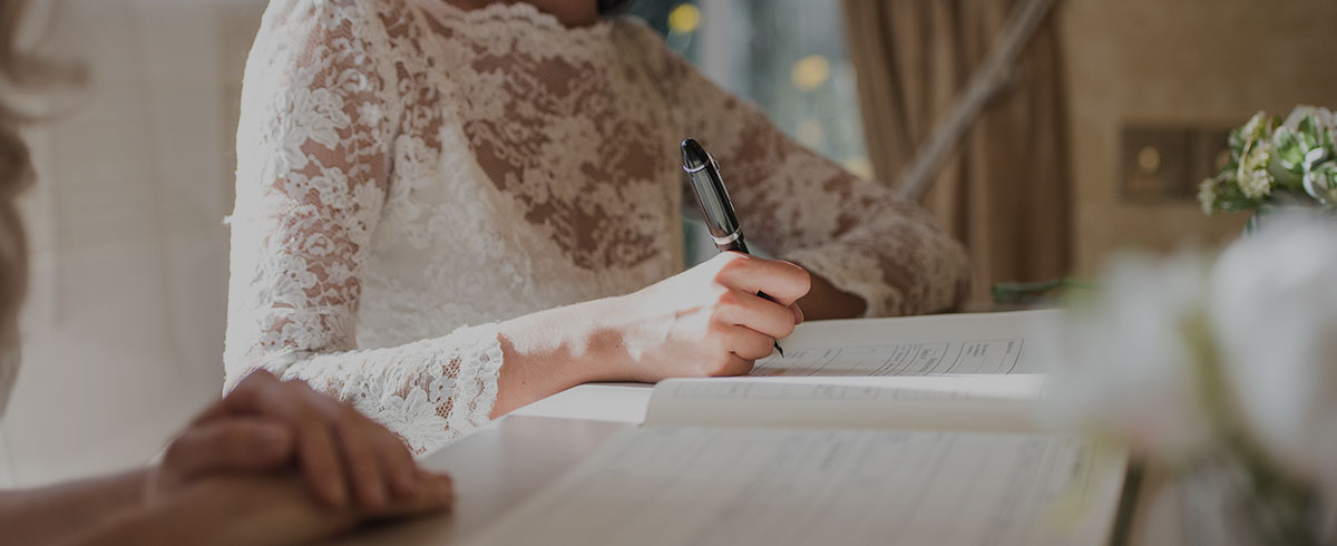 Bride signing a marriage license